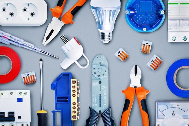 different-electrical-tools-equipment-grey-background-top-view_106035-1335